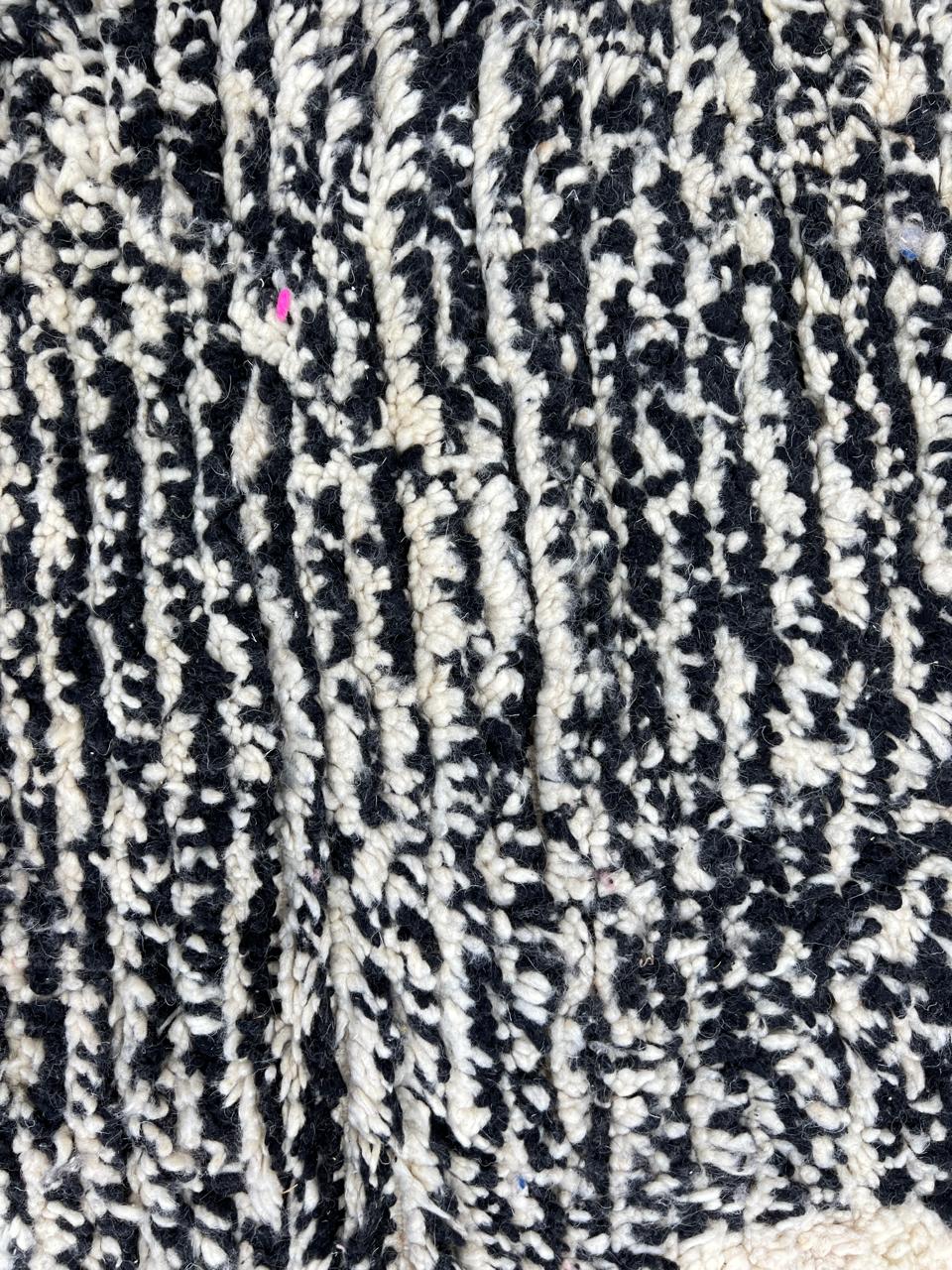Handwoven Moroccan wool rug with abstract modern pattern in ivory, black, and red tones