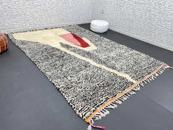Handwoven Moroccan wool rug with abstract modern pattern in ivory, black, and red tones