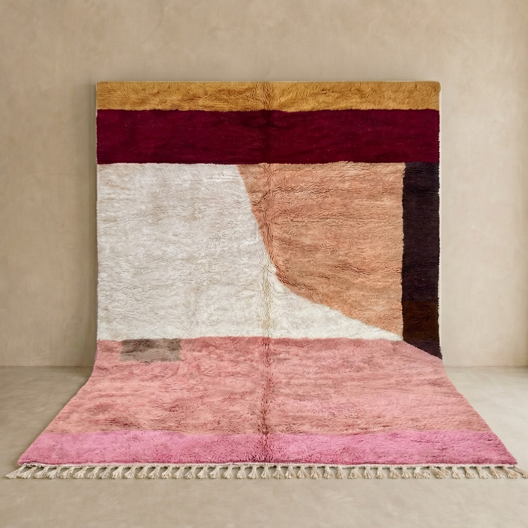 Modern abstract Moroccan wool rug with plush high-pile texture, handmade Berber color block design in pink, cream, peach, burgundy, tan, and dark brown.