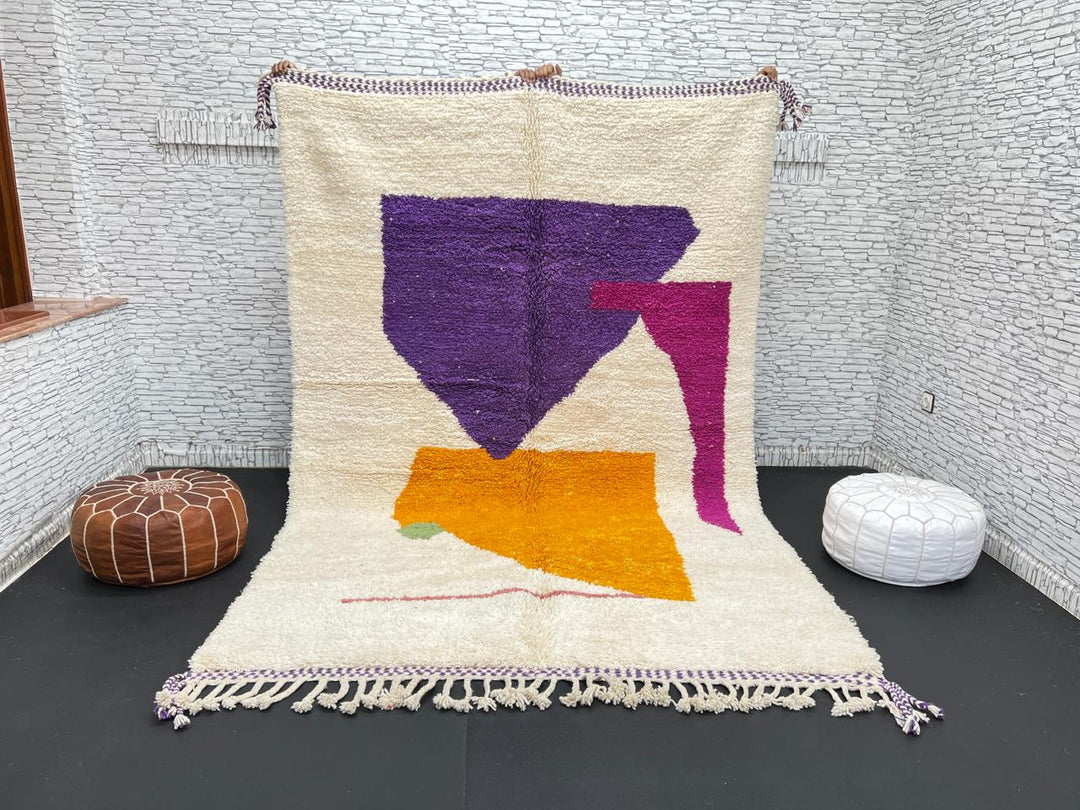 Handwoven Moroccan wool rug with modern abstract geometric shapes in purple, orange, and magenta
