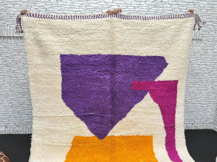 Handwoven Moroccan wool rug with modern abstract geometric shapes in purple, orange, and magenta