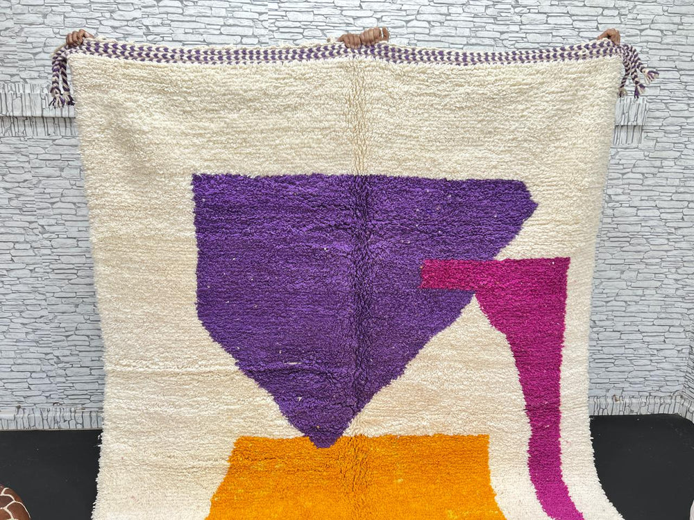 Handwoven Moroccan wool rug with modern abstract geometric shapes in purple, orange, and magenta