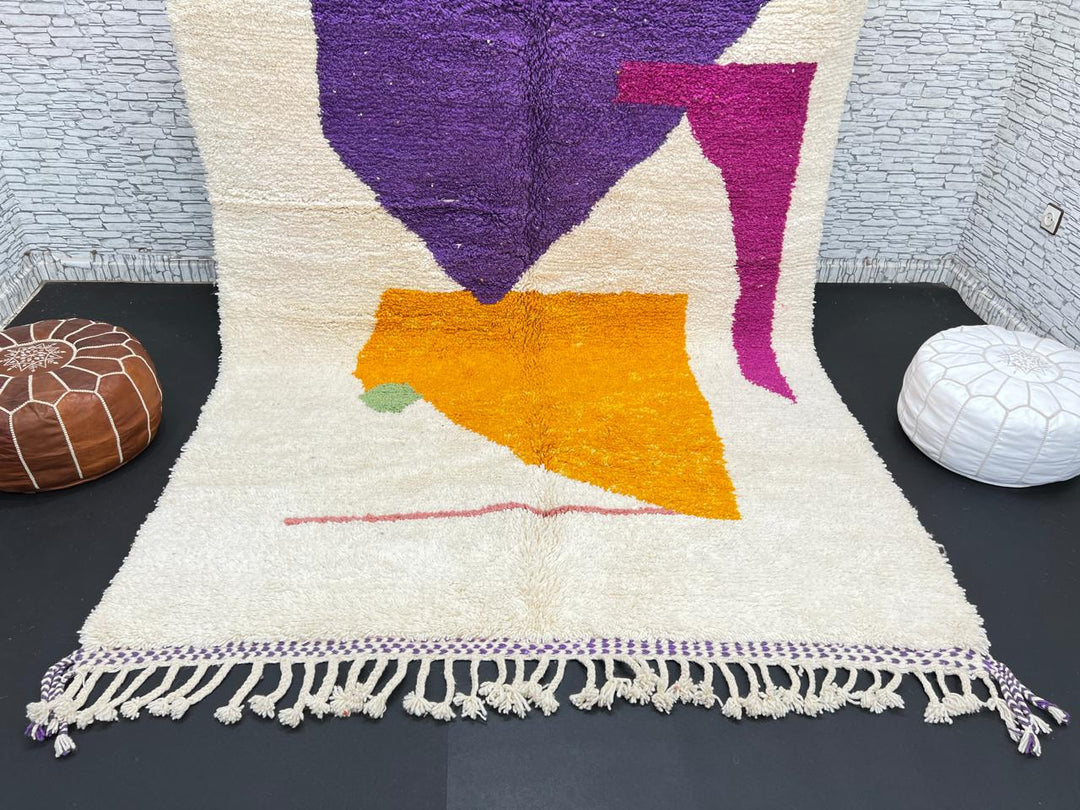 Handwoven Moroccan wool rug with modern abstract geometric shapes in purple, orange, and magenta