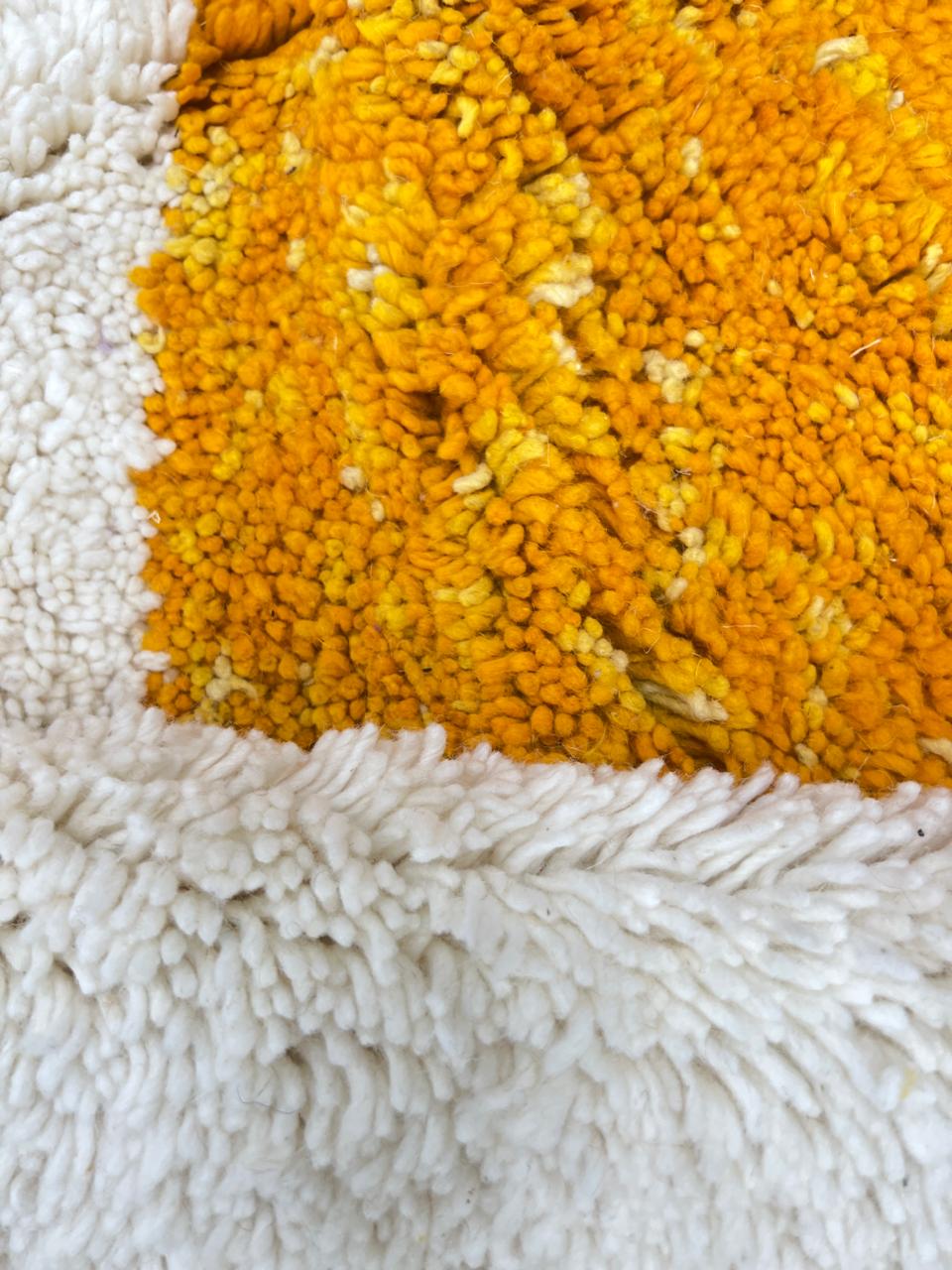 Handwoven Moroccan wool rug with modern abstract geometric shapes in purple, orange, and magenta