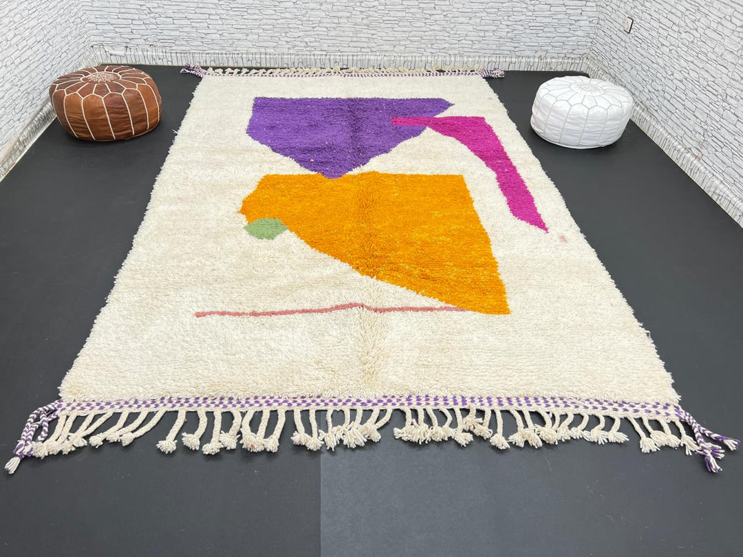 Handwoven Moroccan wool rug with modern abstract geometric shapes in purple, orange, and magenta