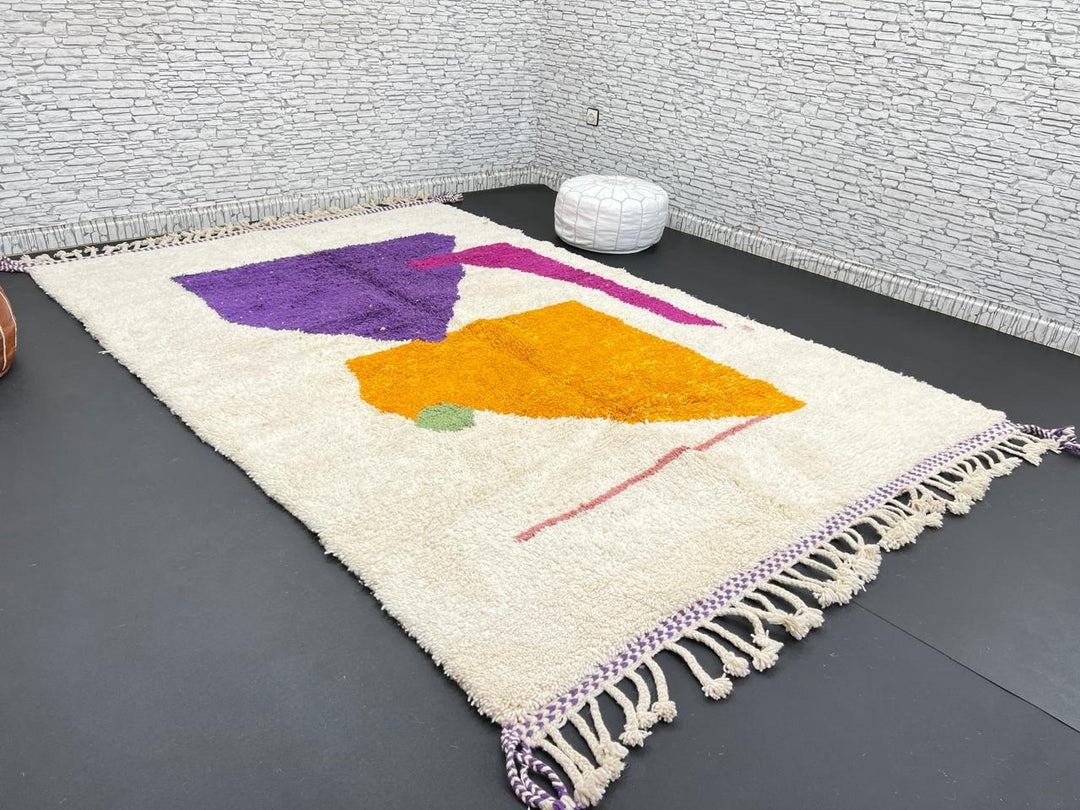 Handwoven Moroccan wool rug with modern abstract geometric shapes in purple, orange, and magenta
