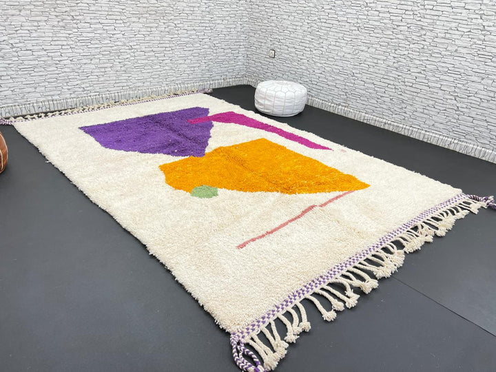 Handwoven Moroccan wool rug with modern abstract geometric shapes in purple, orange, and magenta