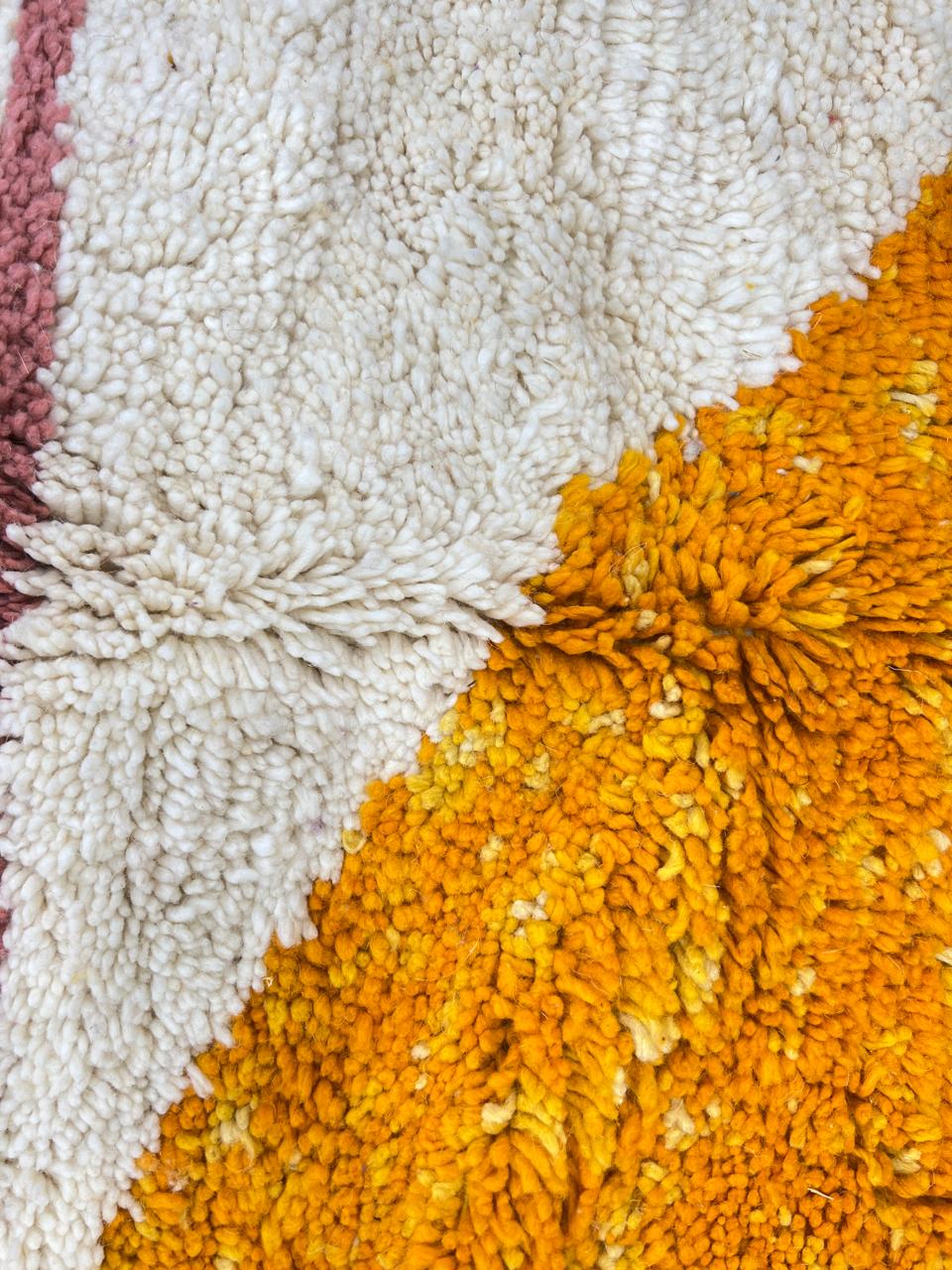 Handmade modern Moroccan wool runner rug with bold abstract geometric shapes in purple, fuchsia, orange, and green on a white background