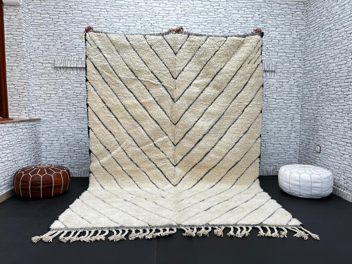 Modern Moroccan Beni Ourain wool rug with black chevron lines on cream background, handmade by Berber artisans