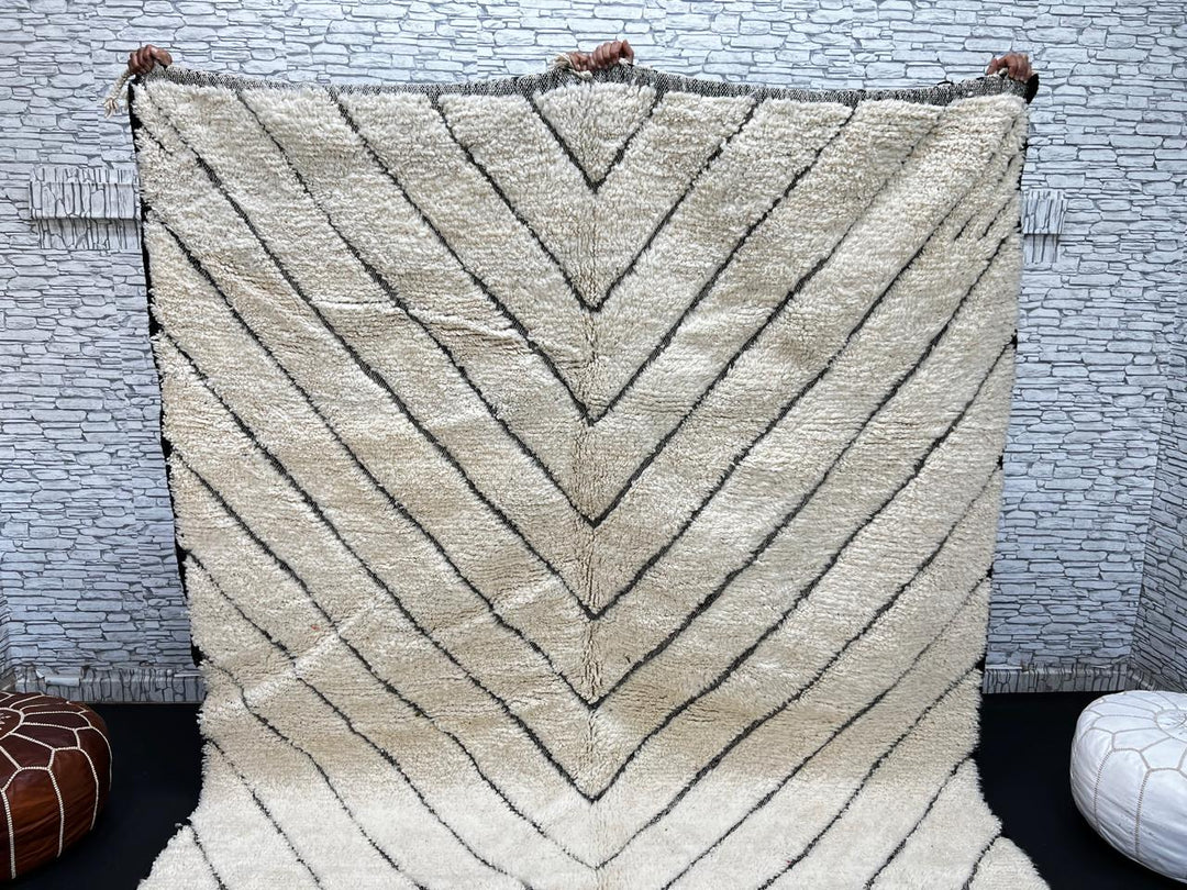 Modern Moroccan Beni Ourain wool rug with black chevron lines on cream background, handmade by Berber artisans