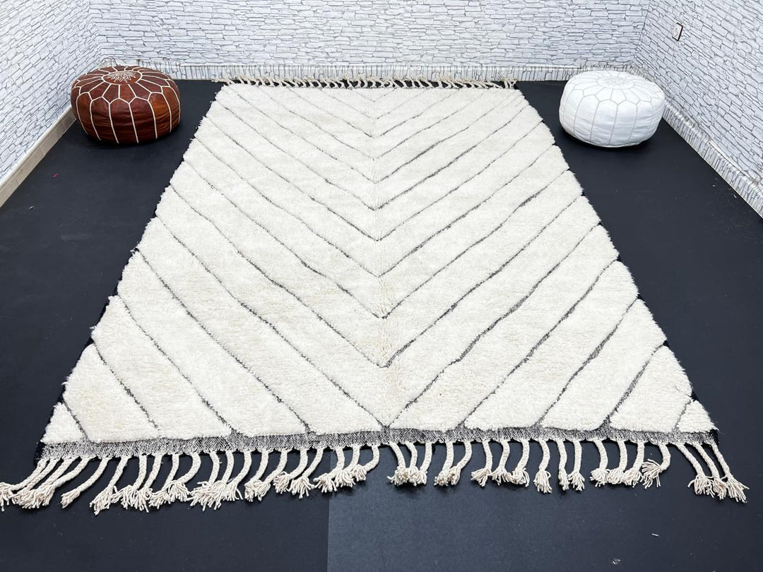 Modern Moroccan Beni Ourain wool rug with black chevron lines on cream background, handmade by Berber artisans