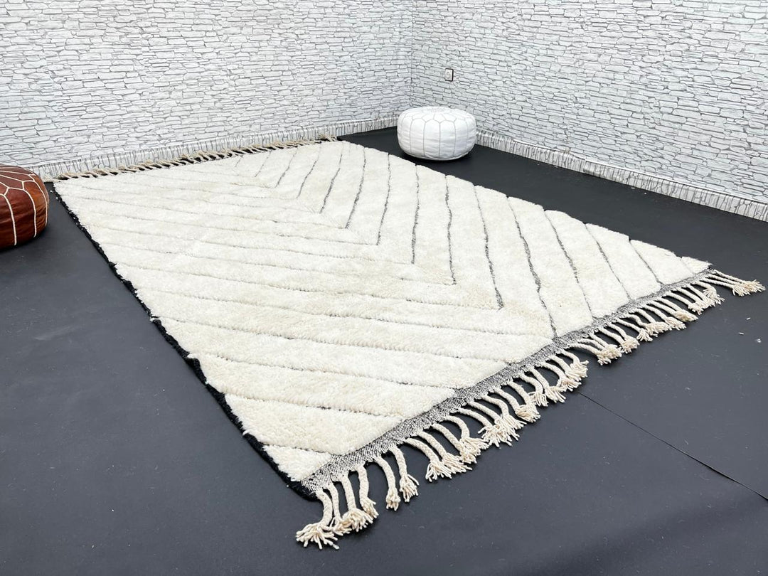 Modern Moroccan Beni Ourain wool rug with black chevron lines on cream background, handmade by Berber artisans