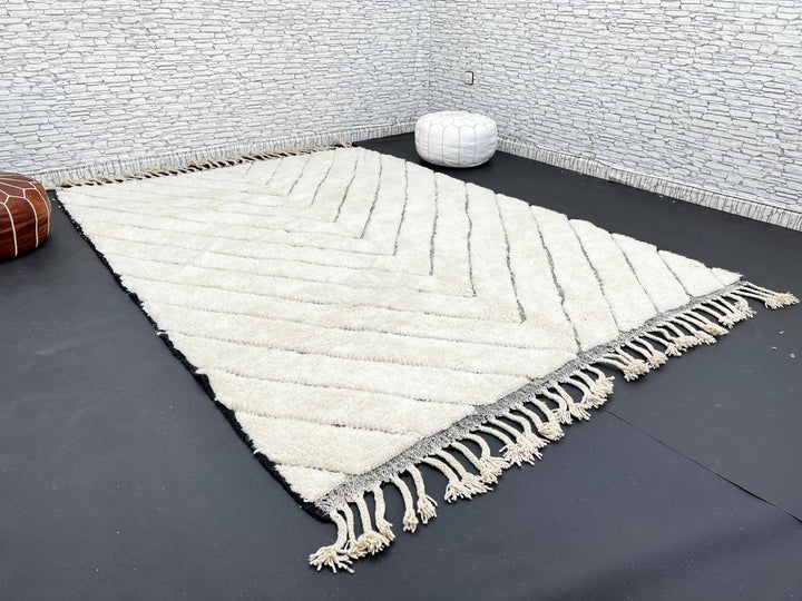 Modern Moroccan Beni Ourain wool rug with black chevron lines on cream background, handmade by Berber artisans