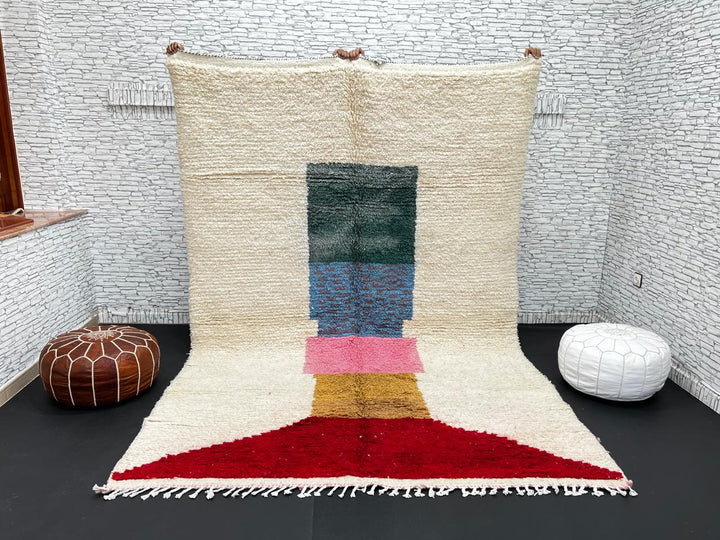 Modern Moroccan wool rug with ivory background and color blocks in green, blue, pink, mustard, and red