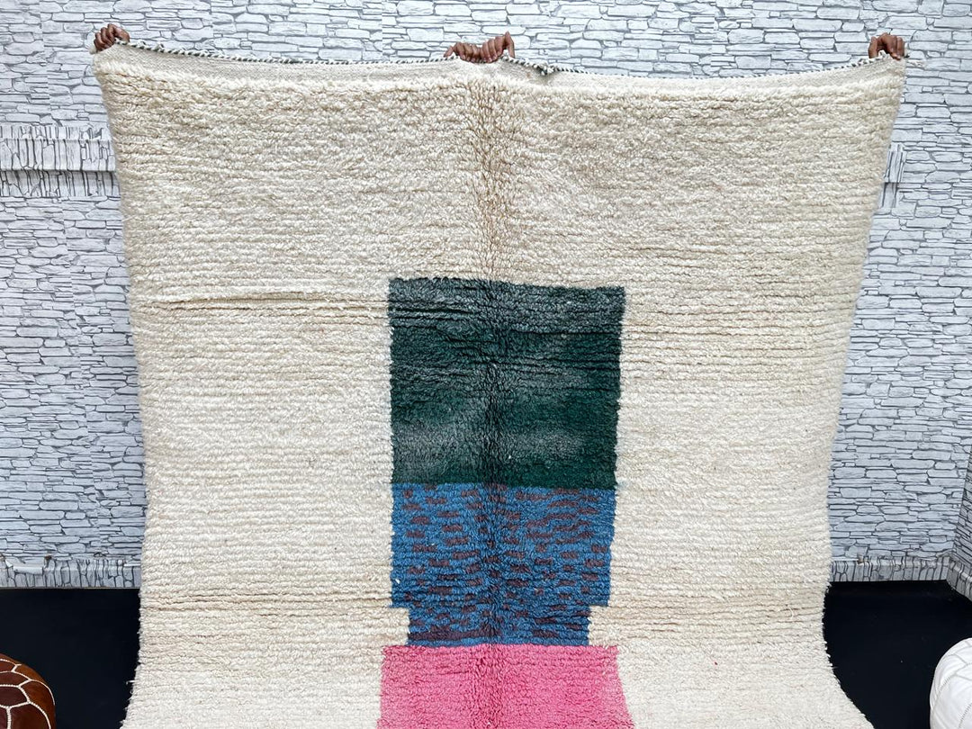 Modern Moroccan wool rug with ivory background and color blocks in green, blue, pink, mustard, and red