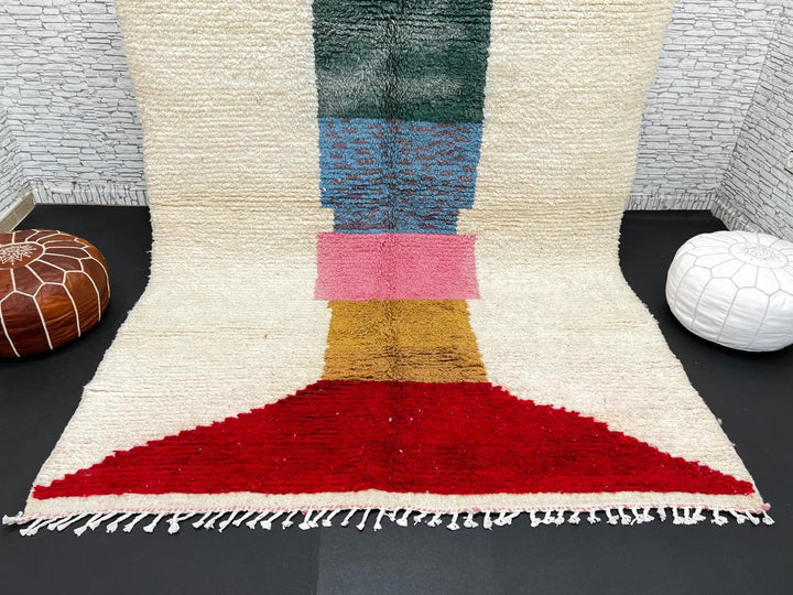 Modern Moroccan wool rug with ivory background and color blocks in green, blue, pink, mustard, and red