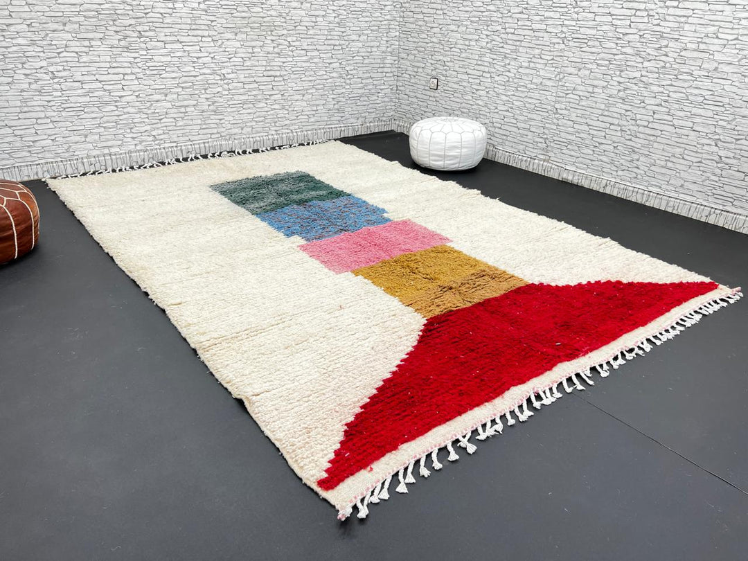 Modern Moroccan wool rug with ivory background and color blocks in green, blue, pink, mustard, and red