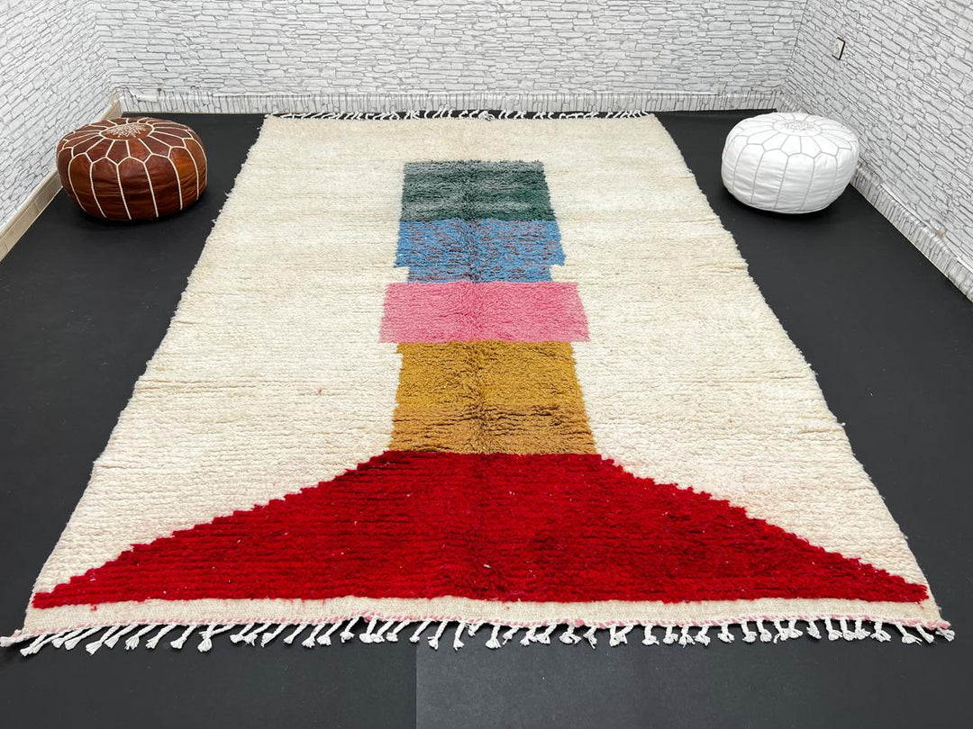 Modern Moroccan wool rug with ivory background and color blocks in green, blue, pink, mustard, and red