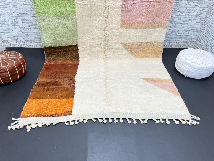 Modern color block Moroccan wool rug with green, pink, brown, and white geometric pattern