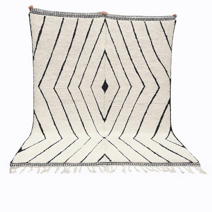 Handwoven Moroccan wool rug with black geometric diamond line pattern