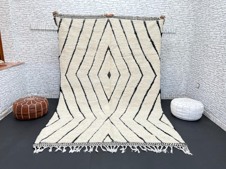 Handwoven Moroccan wool rug with black geometric diamond line pattern