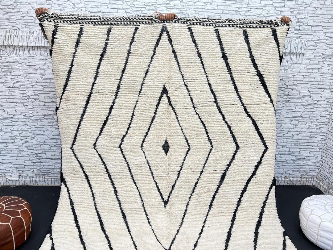 Handwoven Moroccan wool rug with black geometric diamond line pattern