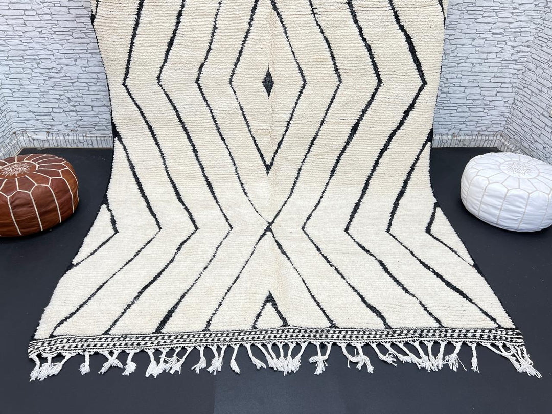 Handwoven Moroccan wool rug with black geometric diamond line pattern