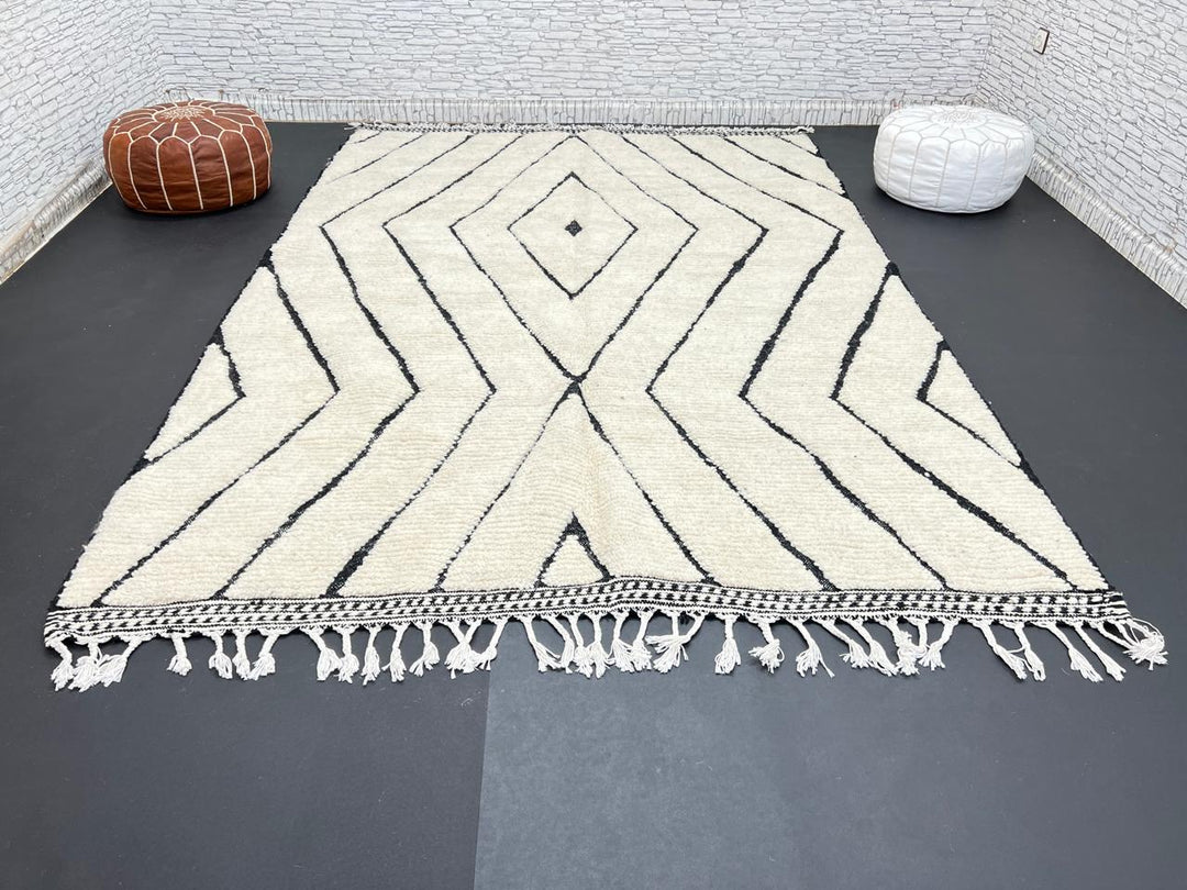 Handwoven Moroccan wool rug with black geometric diamond line pattern