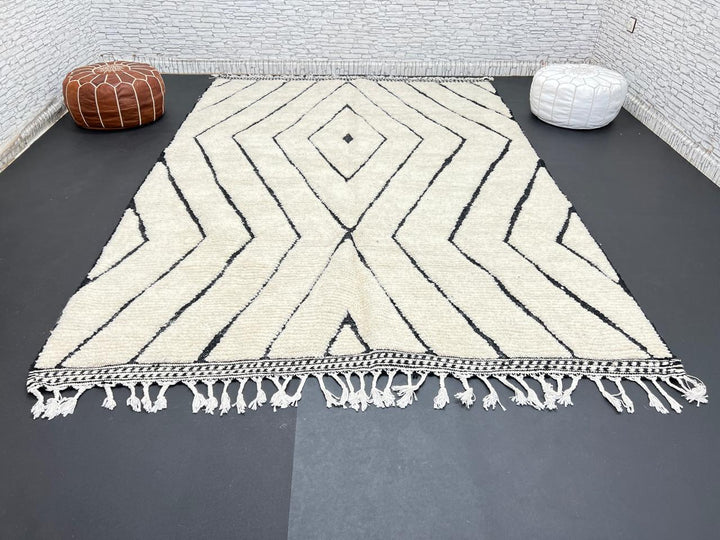 Handwoven Moroccan wool rug with black geometric diamond line pattern