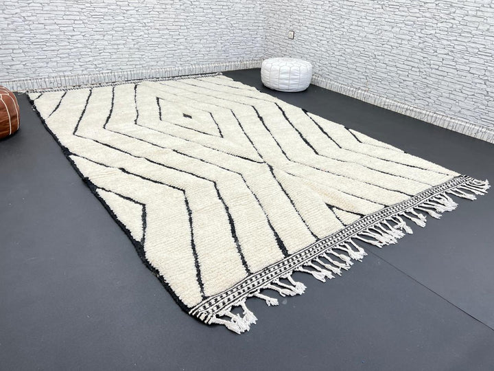 Handwoven Moroccan wool rug with black geometric diamond line pattern