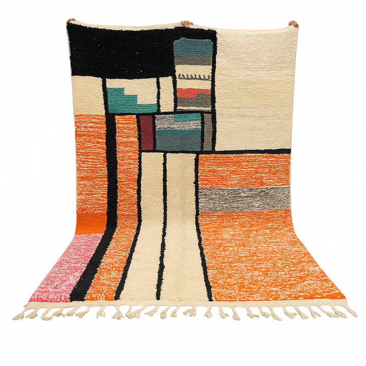 Handmade Moroccan wool rug with geometric color block design in orange, black, teal, and pink tones