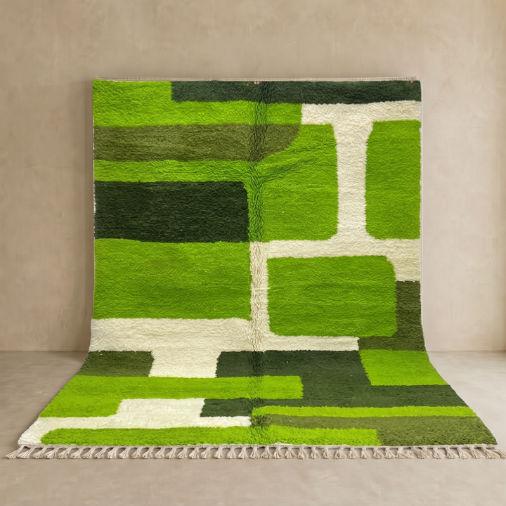 Modern green Moroccan wool rug with geometric Berber pattern and white lines on white background
