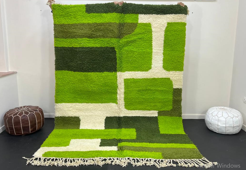 Modern green Moroccan wool rug with geometric Berber pattern and white lines on white background