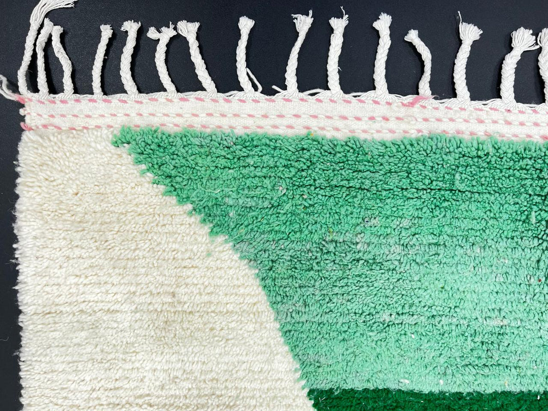 Modern handmade Moroccan wool runner with pink-to-green hourglass design on a white base