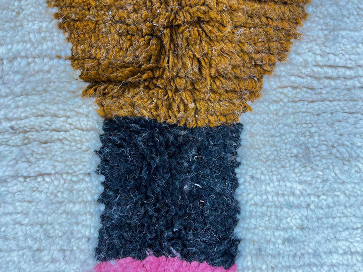 Modern handmade Moroccan wool runner with pink-to-green hourglass design on a white base