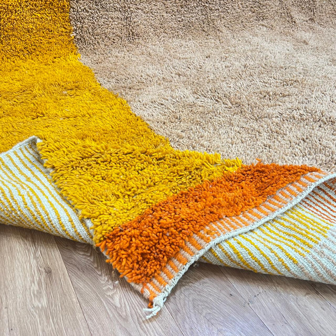 Handmade Moroccan wool rug with minimalist earth-tone design. Soft plush texture, modern style, and ethically crafted in Morocco.