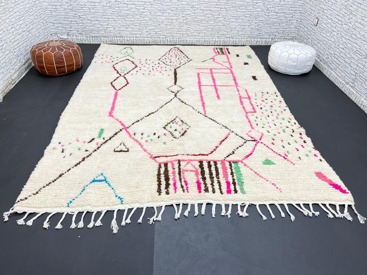 Modern Moroccan Berber wool rug with colorful geometric patterns on a cream background