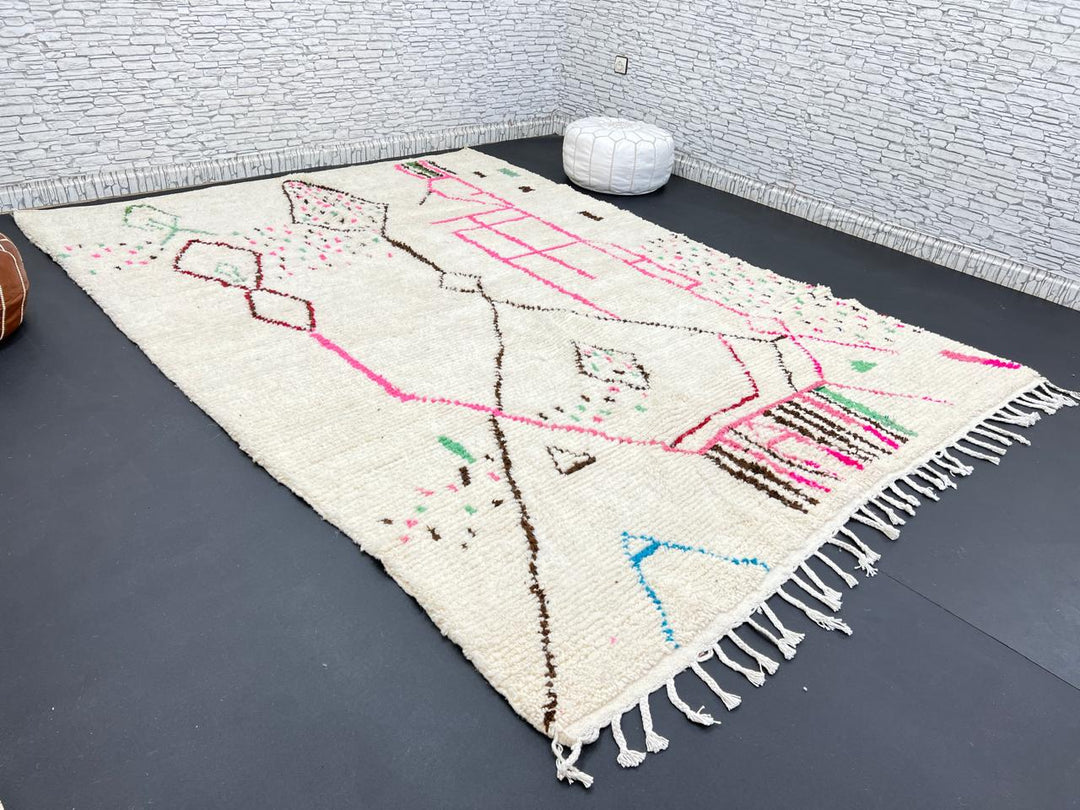 Modern Moroccan Berber wool rug with colorful geometric patterns on a cream background