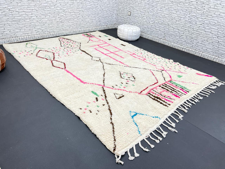 Modern Moroccan Berber wool rug with colorful geometric patterns on a cream background