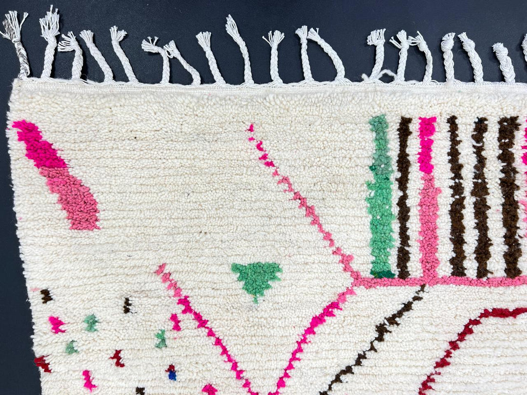 Modern Moroccan Berber wool rug with colorful geometric patterns on a cream background