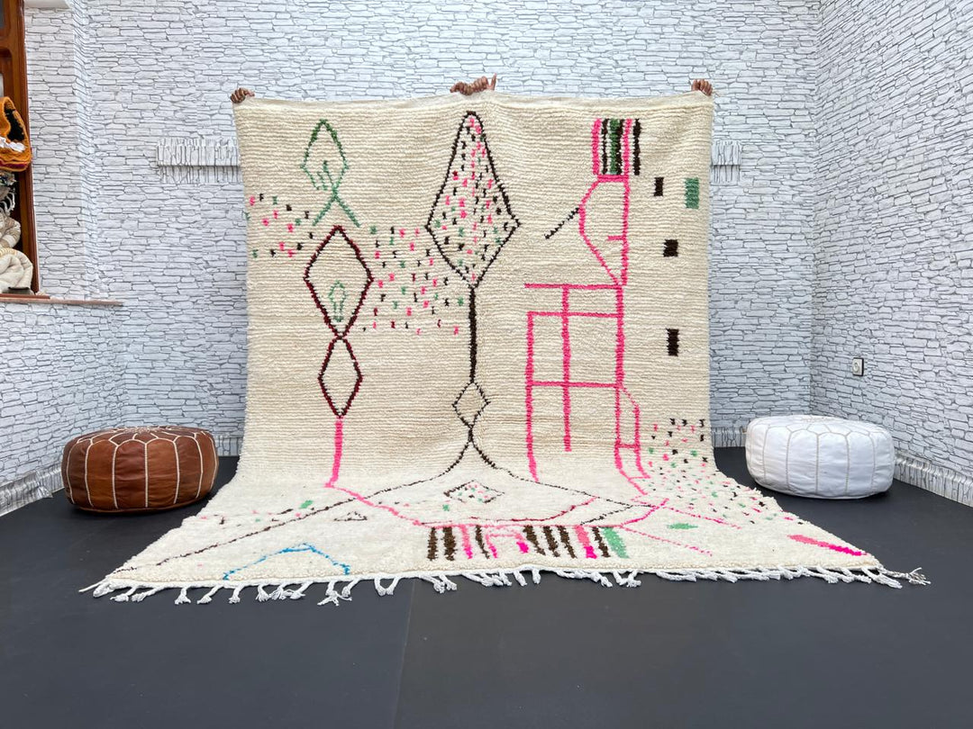 Modern Moroccan Berber wool rug with colorful geometric patterns on a cream background