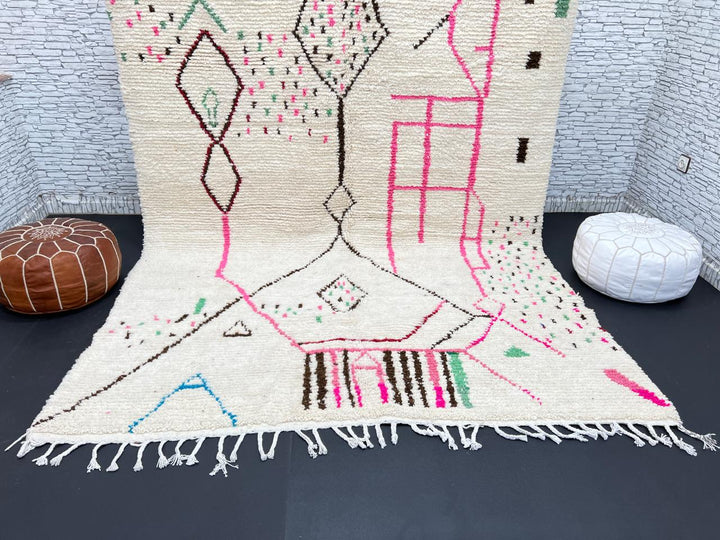 Modern Moroccan Berber wool rug with colorful geometric patterns on a cream background