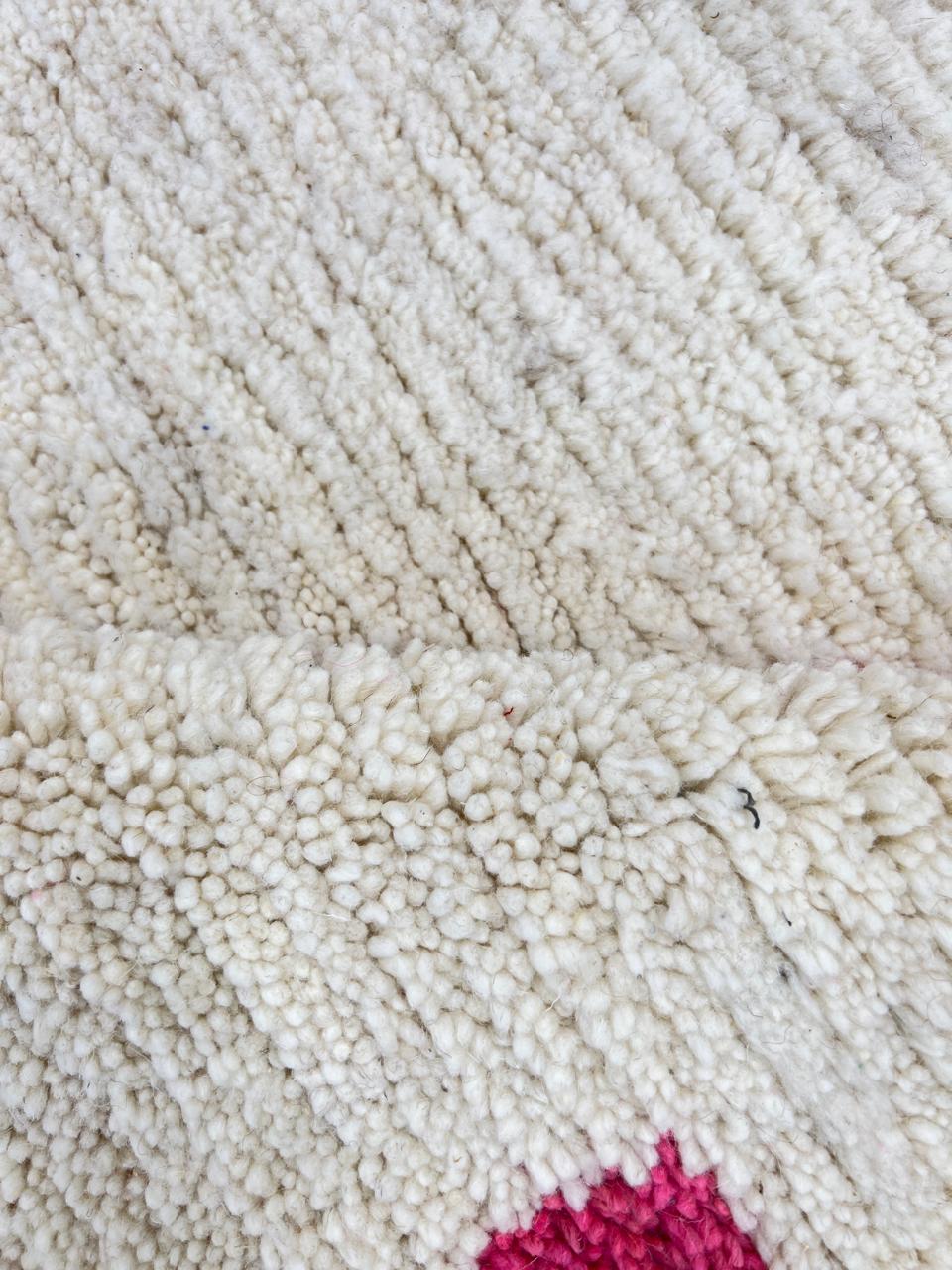 Modern Moroccan Berber wool rug with colorful geometric patterns on a cream background