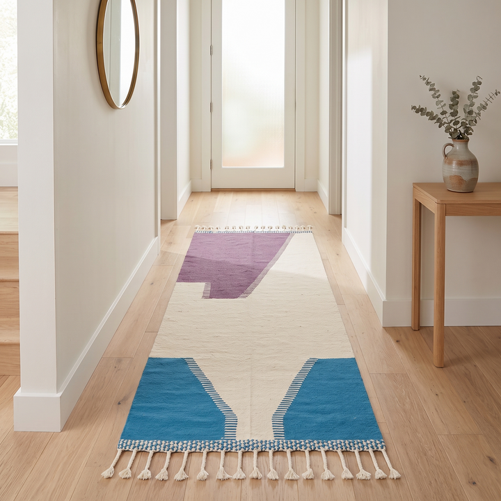 Handmade Moroccan kilim runner rug with purple and blue geometric design on white background, flatwoven hallway runner