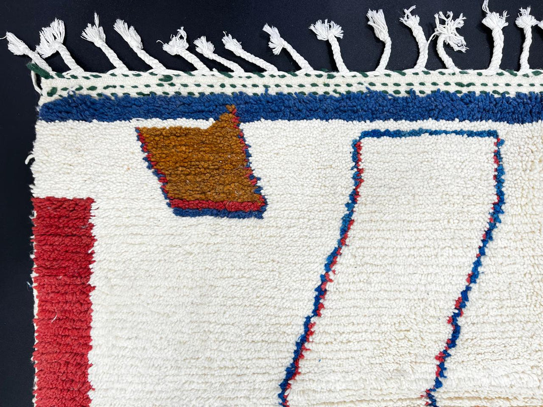 Modern Moroccan runner rug with abstract Berber design in blue, green, red and white, handmade wool hallway carpet with tribal motifs