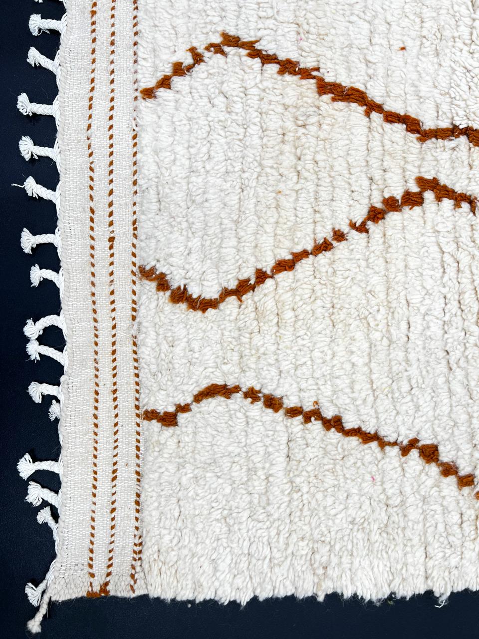 Handmade white Moroccan runner rug with brown geometric tribal diamond pattern.