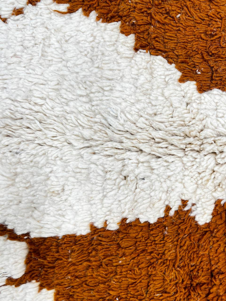 Handmade white Moroccan runner rug with brown geometric tribal diamond pattern.