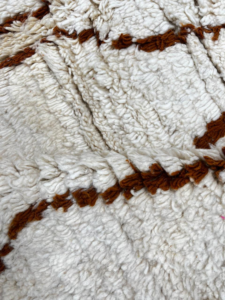 Handmade white Moroccan runner rug with brown geometric tribal diamond pattern.