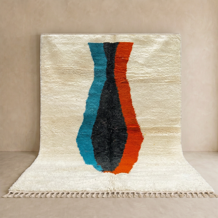 Beige Moroccan wool rug with central abstract design in blue, black, and orange, handmade by Berber artisans