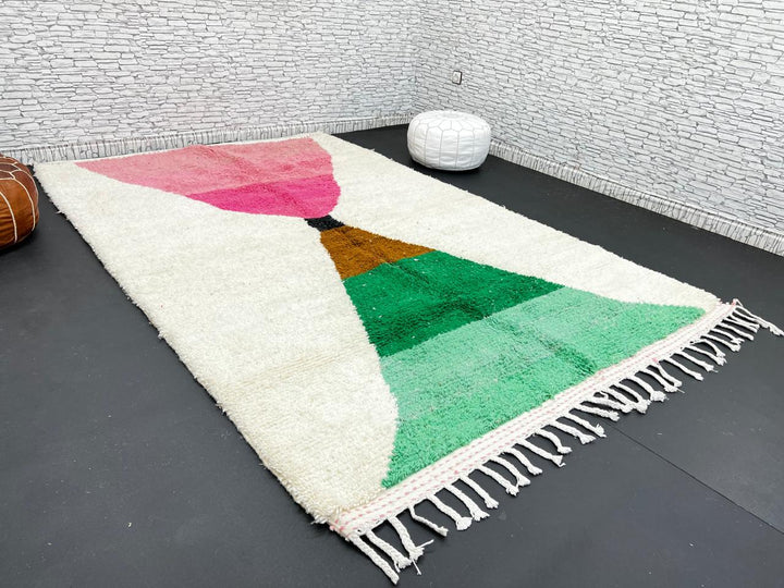 Modern Moroccan wool rug with pink and green hourglass geometric design, handmade by Berber artisans